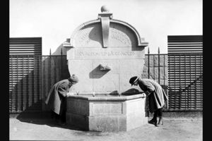 14 Fotograf ukjent, 1922. Byarkitekten. Bildenummer: A-20031/Ua/0003/007.Utlånt av Oslo byarkiv. Bildetekst: Drikkefontene, to jenter som drikker vann. "I MIMERS BRØND ER VANDET KOLDT. FRA HEDENHOLD I ÆRE HOLDT". Herslebs skole 1922